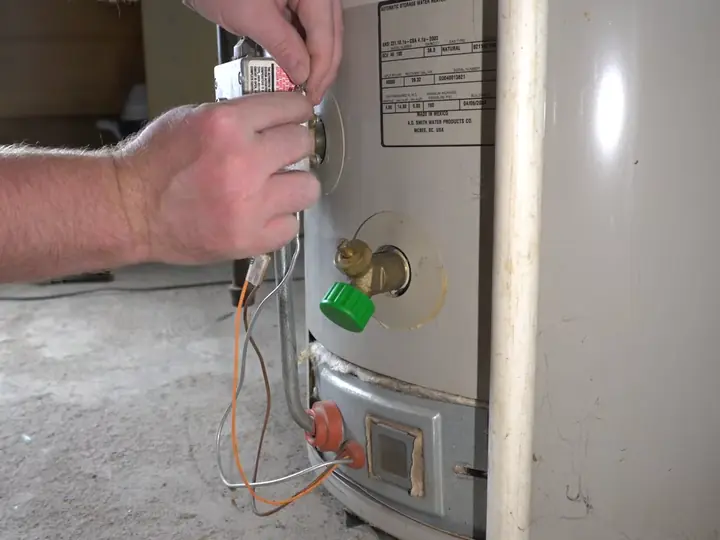 Gas water heater repair in Revere, MA with a technician replacing the thermocouple